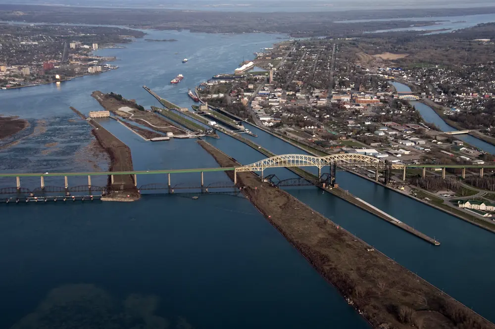 Aerial view of the Soo Locks beside the city of Sault Ste. Marie with the International Bridge crossing the St. Marys River