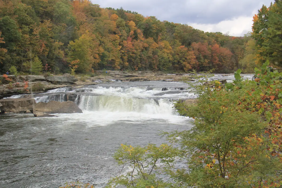 Wooded hillsides in red, orange and yellow autumn color above the Youghiogheny River valley at Ohiopyle State Park